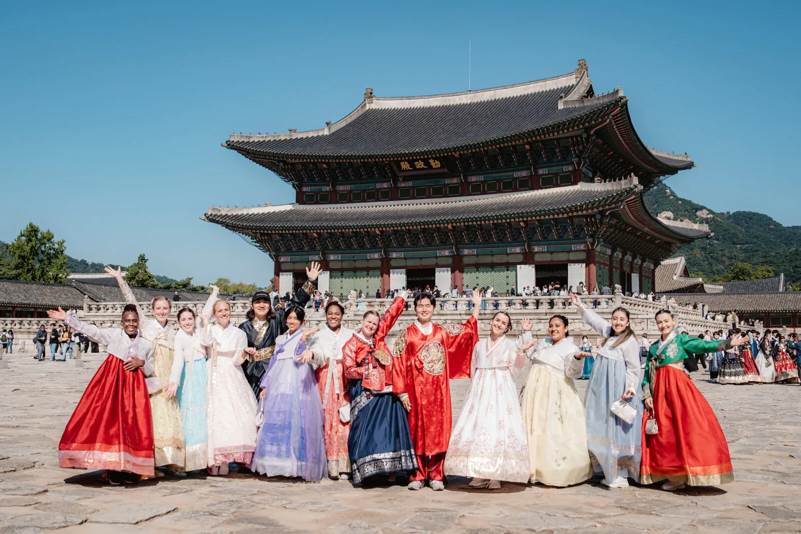 Students waving in hanbok